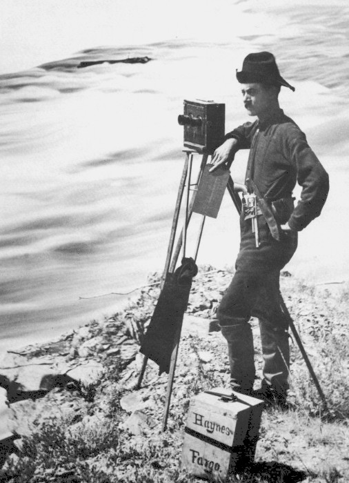 Photo of a man with a camera on a tripod