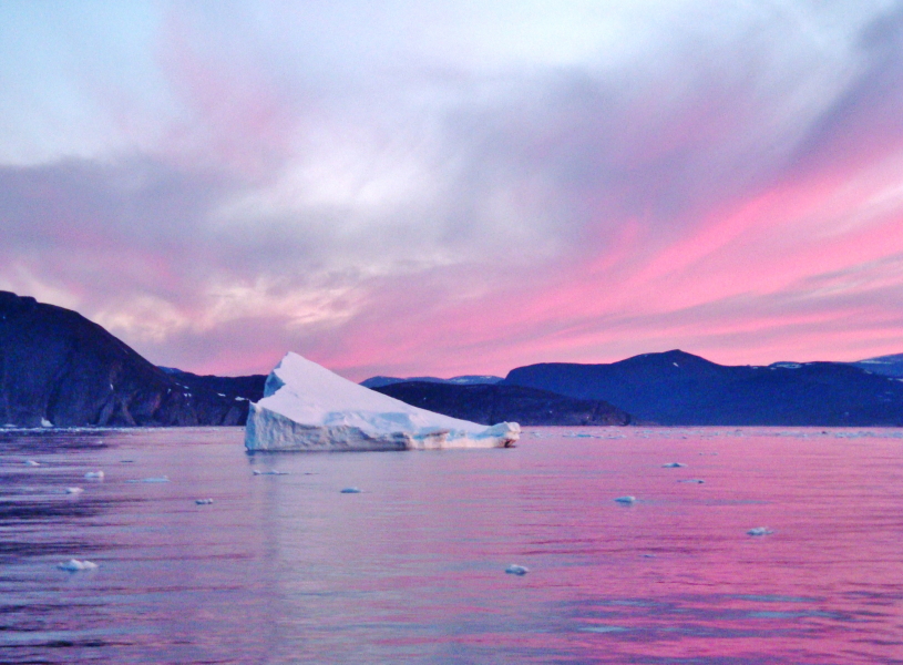 Iceberg against pink sky