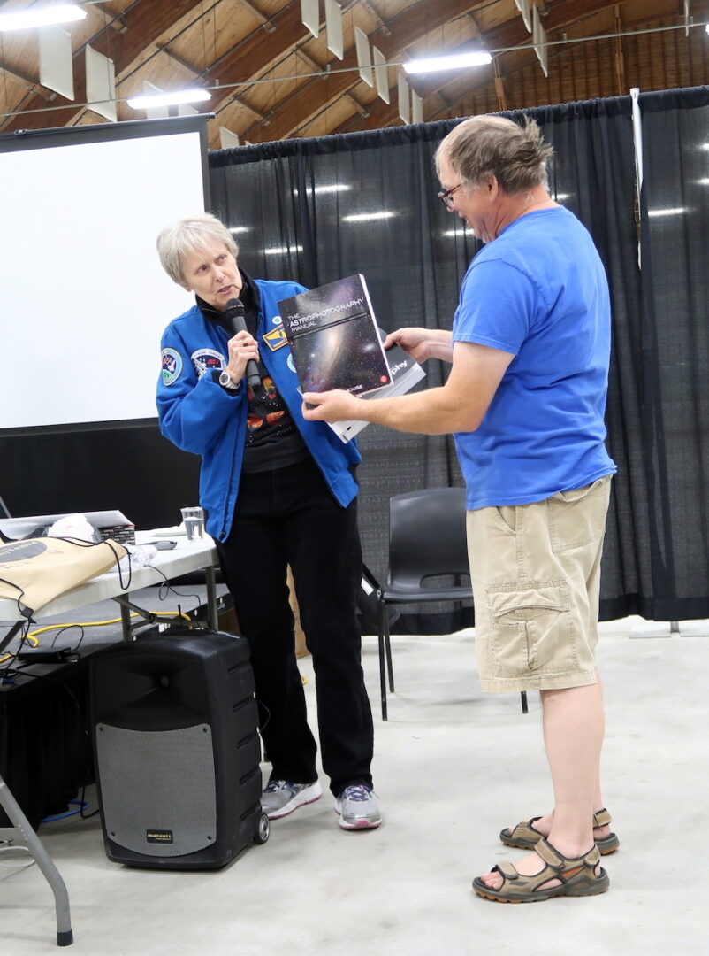 Dr Bondar presents Mike Couvrette, Thebacha & Wood Buffalo Astronomical Society, with an Astrotrak auto guiding tracking mount +astrophotography books