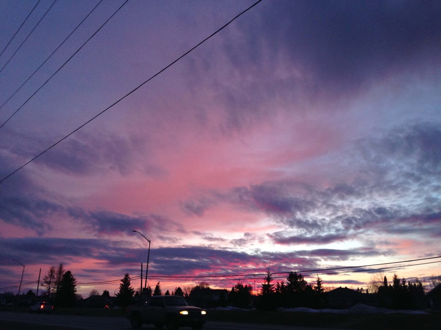 Image of pink clouds over a road
