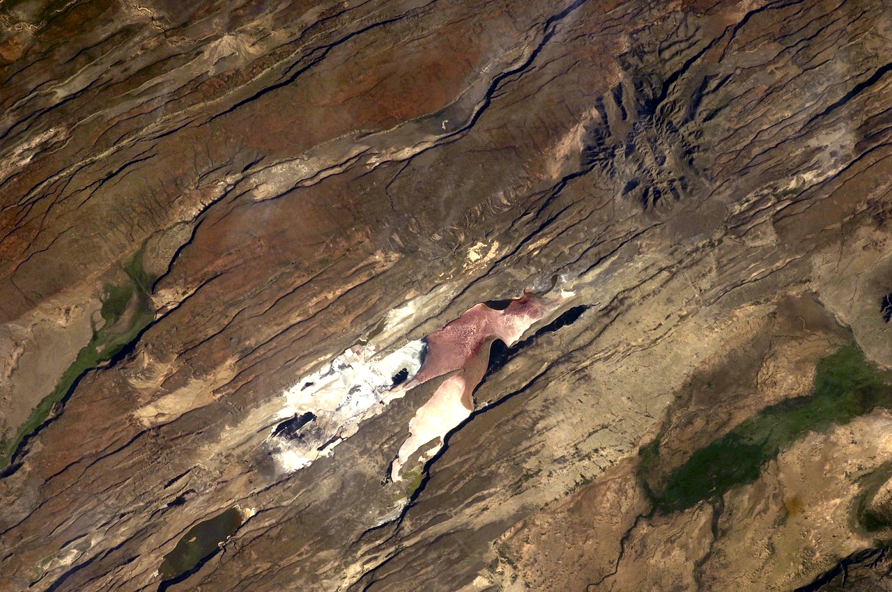 Satellite image of pink land in brown landscape