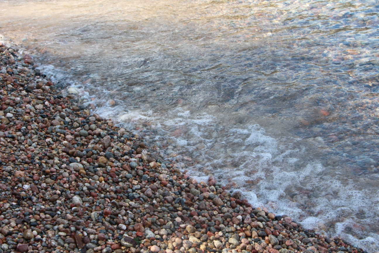 Image of a rocky beach meeting water