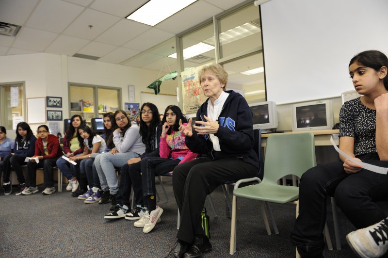 Dr Roberta Bondar works with young women leaders at a school