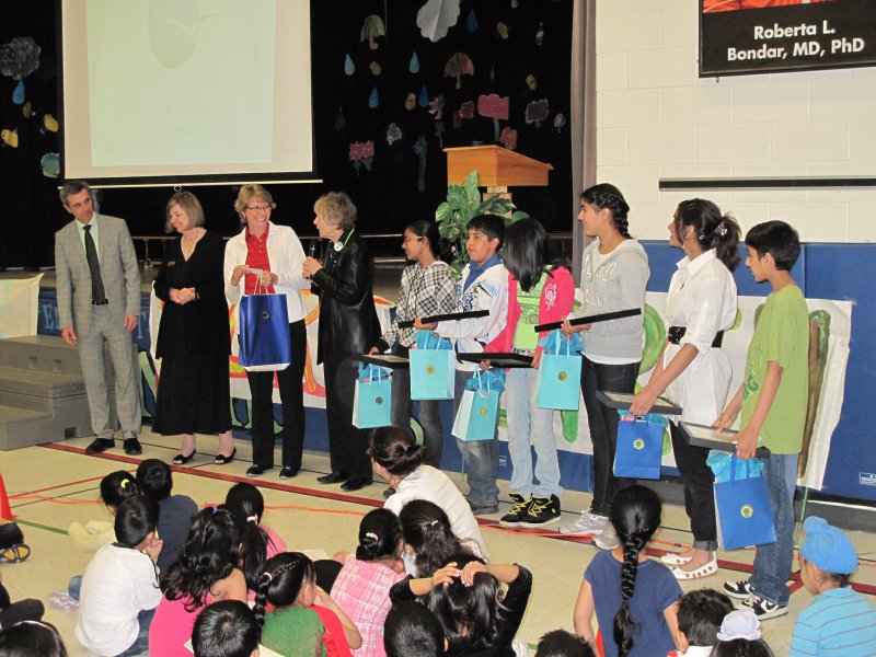 Dr Roberta Bondar with representatives of the School Board, Librarian of the School and student winners being presented their prizes in front of the school assembly