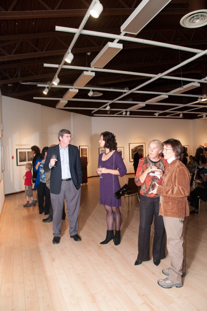 Patrons discuss photographs at the Traveling Exhibition and Learning Experience