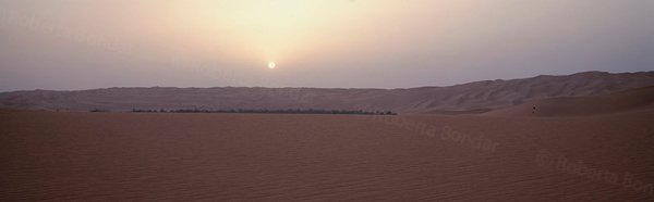 Image of sun over desert sand